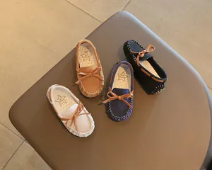 Classic children's moccasins with bow knot detail in various colors for spring