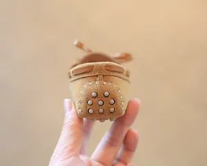 Detailed close-up showing the non-slip pebble heel of tan suede children's loafers