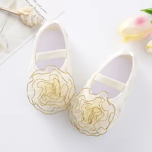 Close-up detail of cute baby princess shoes with large floral lace and soft soles