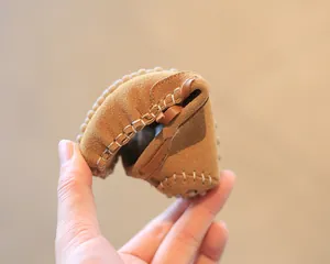 Detail view showing the extreme flexibility and soft suede texture of toddler loafers.