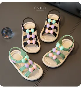 Detailed view of kids' summer sandals with colorful bow decorations and soft soles