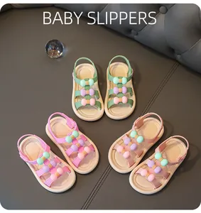 Detailed view of girls' summer sandals with colorful bow decorations and elastic straps