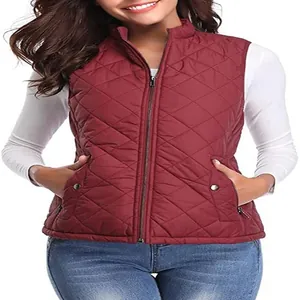 Detail of women's burgundy quilted vest featuring stand collar and zipper pockets.