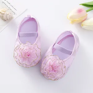 Close-up of adorable lavender baby princess shoes featuring a large ruffled mesh flower