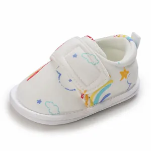 Vue détaillée d'une chaussure pour bébé avec motifs arc-en-ciel et bande velcro