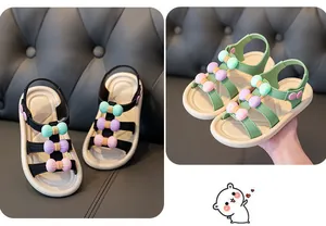 Detailed view of fashionable girls summer sandals with colorful bow accents and soft soles.