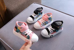 Dettaglio di scarpe alte in tela a scacchi colorate per bambini con chiusura a strappo