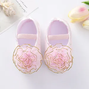 Close-up detail of pink baby princess shoes featuring a large 3D mesh flower decoration