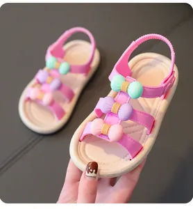 Pink girls' sandals with colorful bows and soft white soles for summer beach wear.