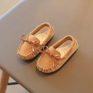 Classic brown suede children's loafers with bow detail and hand-stitched edges