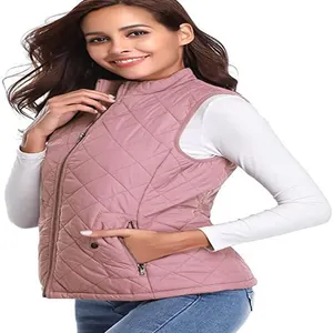 Detail of women's dusty rose quilted vest featuring a stand collar and zipper pockets.