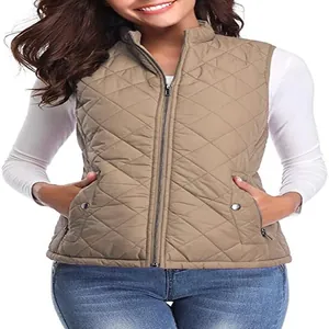 A detailed view of a women's tan quilted vest featuring a stand collar and zipper pockets