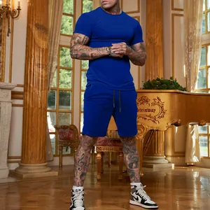 Man wearing royal blue slim fit t-shirt and shorts set in a luxury interior scene
