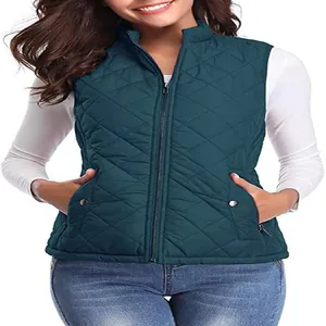 Close-up of a women's dark teal quilted vest with stand collar and zipper closure.