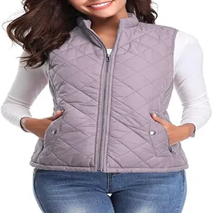 Detailed macro view of women's mauve quilted vest with stand collar and pockets.