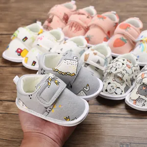 Gros plan de chaussures de marche bébé à semelle souple avec motifs dessins animés