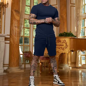 Full view of navy blue men's short sleeve T-shirt and shorts athletic set on model