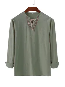 Sage green cotton long sleeve shirt with tribal embroidered lace-up V-neckline detail.