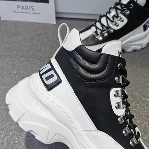 Primo piano di sneaker alta bicolore nero e bianco con occhielli in metallo e suola