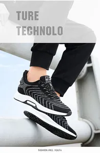Close-up detail of breathable black fly-knit men's sneakers with thick white comfort soles.