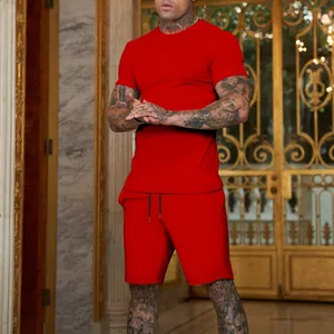 Detailed macro view of a vibrant red men's sports T-shirt and shorts set shown on a model