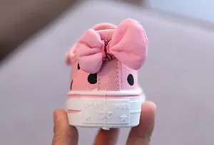 Detailed view of the pink canvas shoe heel featuring a large bow and star pattern