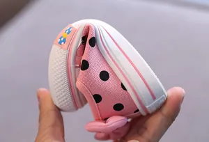 Flexible soft sole of pink polka dot canvas toddler shoes for girls with bow detail