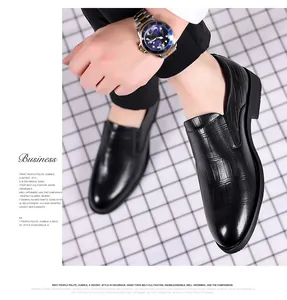 Close-up detail of black crocodile-embossed genuine leather business shoes for men