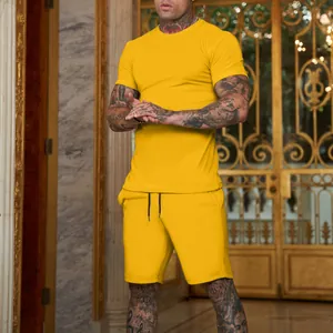 Man in bright yellow solid t-shirt and matching shorts set in a luxury interior