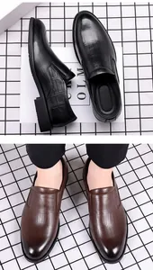 Black and brown men's leather dress shoes with crocodile texture detail view