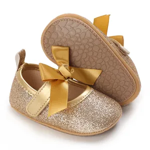Close-up detail of gold glitter baby princess shoes showing non-slip soft rubber sole