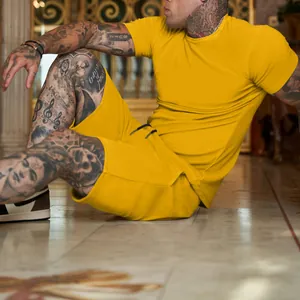 Side view of men's bright yellow solid color T-shirt and shorts set for summer fitness