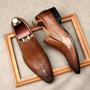 Men's brown crocodile pattern leather dress shoes with pointed toe and wooden shoe trees