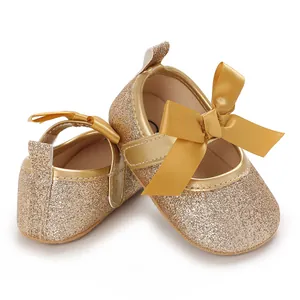 Adorable gold glitter baby girl princess shoes featuring a satin bow and soft sole