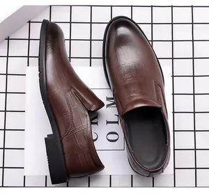 Top-down view of men's brown leather dress shoes with crocodile texture