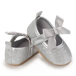 Glittery silver baby girl princess shoes with decorative bows and soft non-slip soles