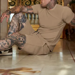 Detail view of a man sitting in tan athletic wear showing fabric texture and fit