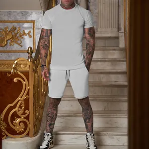 Men's light grey short sleeve T-shirt and shorts set on model in luxury interior