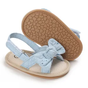 Detailed view of blue baby girl sandals with lace bow and non-slip rubber soft sole