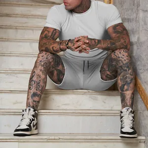 High-quality men's grey solid color short sleeve T-shirt and shorts set on model sitting