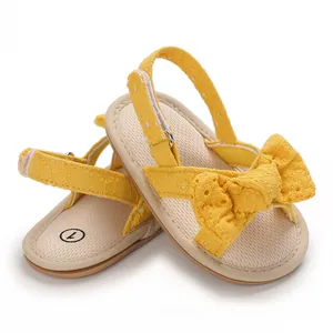 Detailed view of yellow baby girl sandal with embroidered floral bow and soft sole
