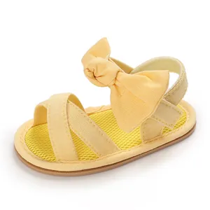 Detailed view of yellow baby girl summer sandal with mesh insole and large bowknot