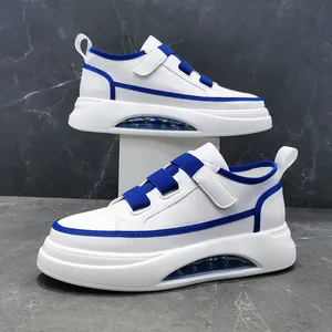 Detailed side view of stylish white men's high-top sneakers with blue trim and thick soles