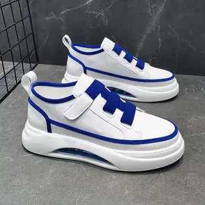 Detailed side view of men's white sneakers with blue accents and chunky platform air soles
