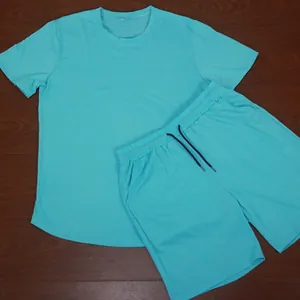 Bright cyan men's summer sports set with t-shirt and drawstring shorts on wooden floor