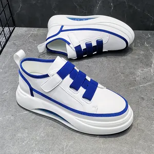 Detail showing blue Velcro straps on white thick-sole high-top leisure sneakers.
