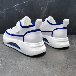 Close-up of men's white platform sneakers with blue trim and air cushion soles
