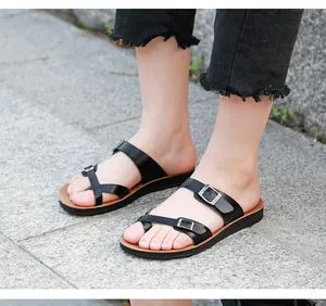 Detailed macro view of comfortable black microfiber flat sandals with adjustable buckles