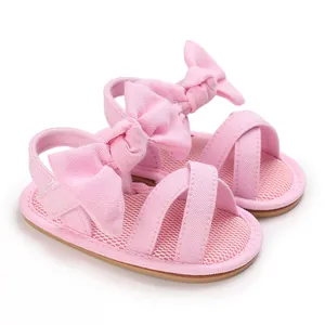 Detailed view of pink infant girls' bow sandals with breathable mesh insole