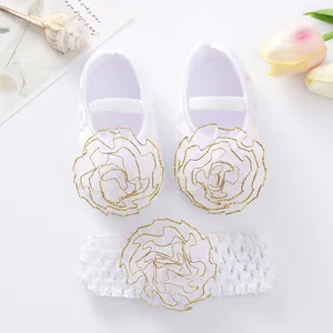 White baby shoes and headband set with gold-edged lace flowers